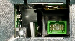 Example of a VeEX competitor's Replaceable Optical Connector Module slot exposing internal components and optical end-face to external elements. The SC connector sits far inside of the instrument, making it difficult to clean and inspect.