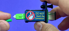 Generic representation of VeEX competitor's Replaceable Optical Connector Module exposing internal optical end-face to accidental contact and contamination.